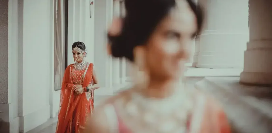 Bridal portrait for the getting-ready photography guide in Indore Bride in a red lehenga reflected in a mirror, bridal portrait by Wedding Photographer in Indore - WPI