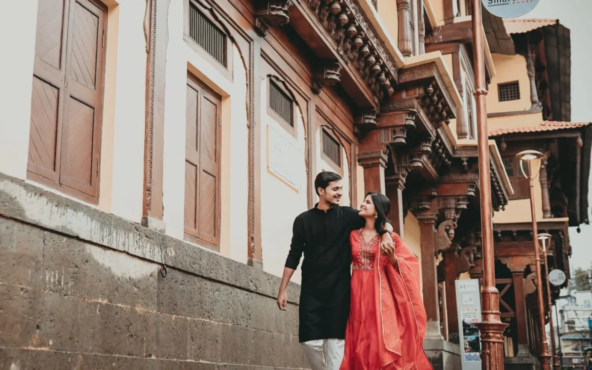Couple walking through an old Indore street, a documentary wedding photography moment