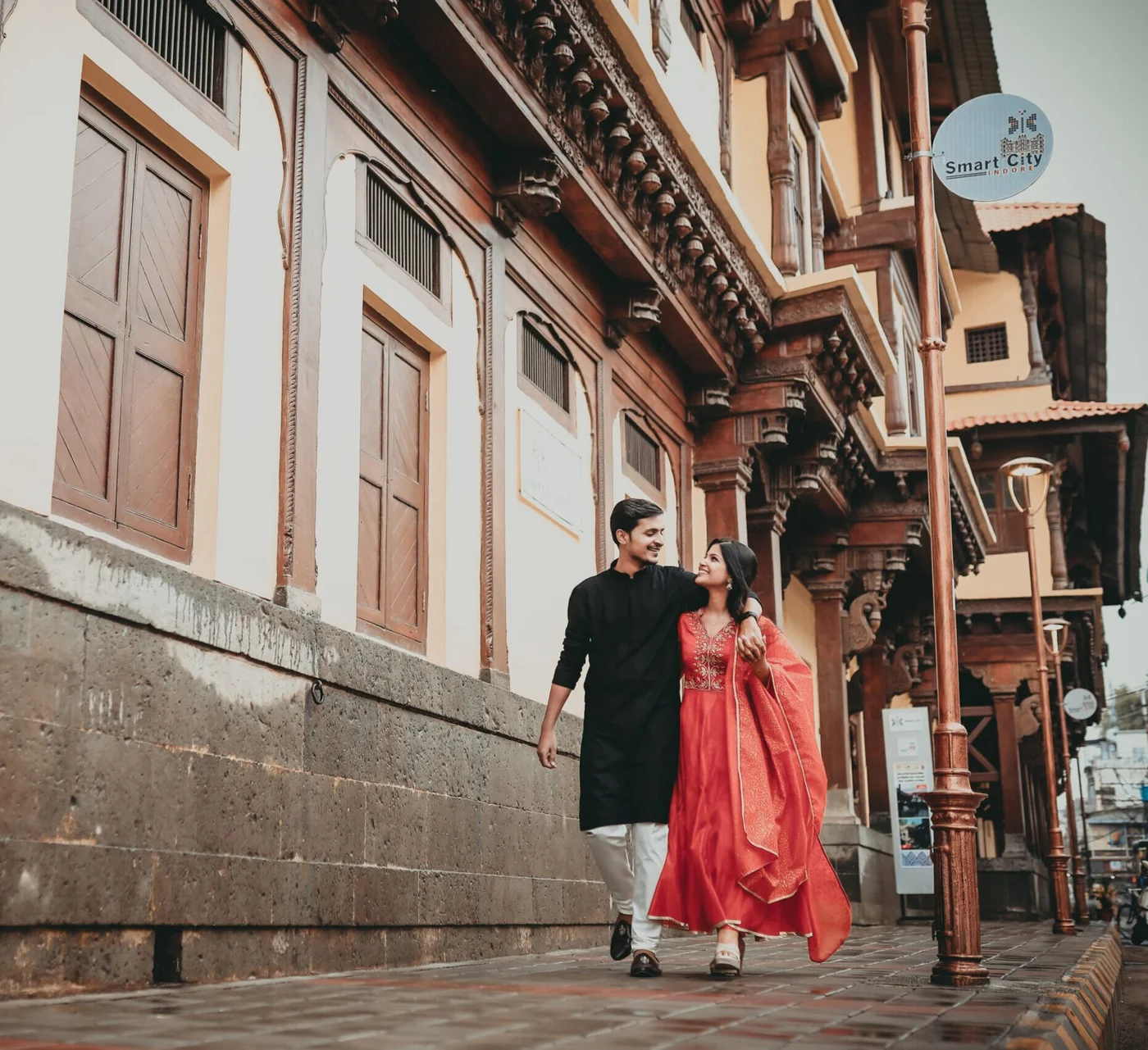Couple walking through an old Indore street, a documentary wedding photography moment