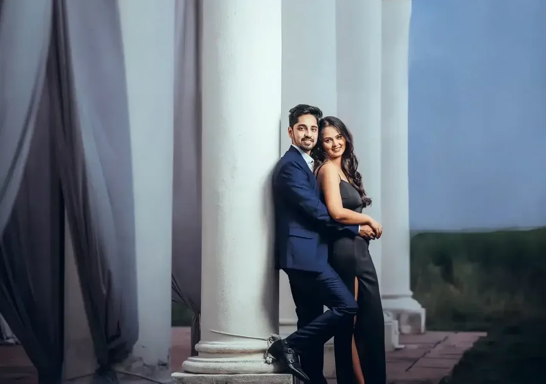 Couple standing beside white columns, portrait preserved in a wedding photo archive
