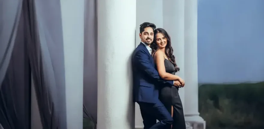 Wedding photo backup guide for Indore couples Couple standing beside white columns, portrait preserved in a wedding photo archive