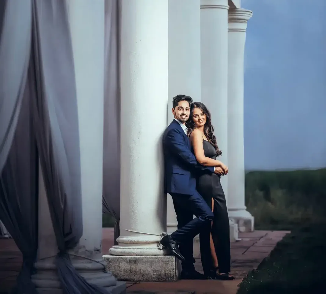 Couple standing beside white columns, portrait preserved in a wedding photo archive