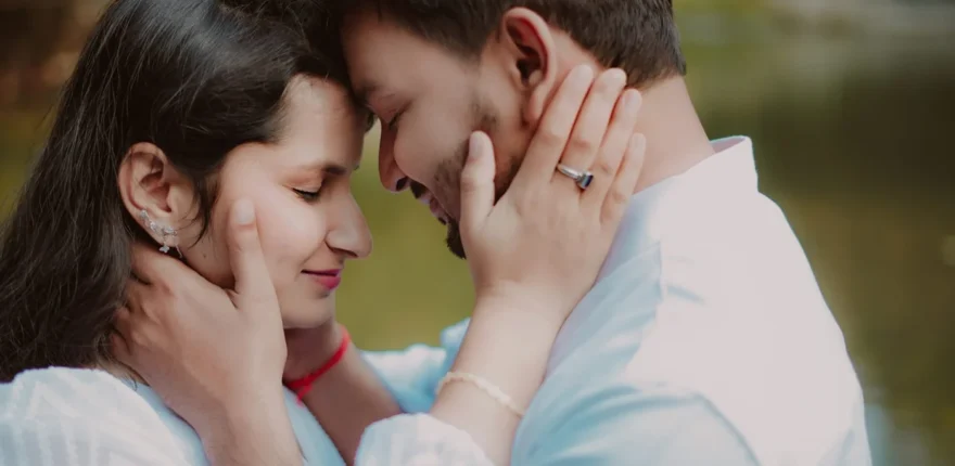 Wedding ring photography - a ring within a couple portrait Couple touching foreheads with a ring visible on the woman's hand