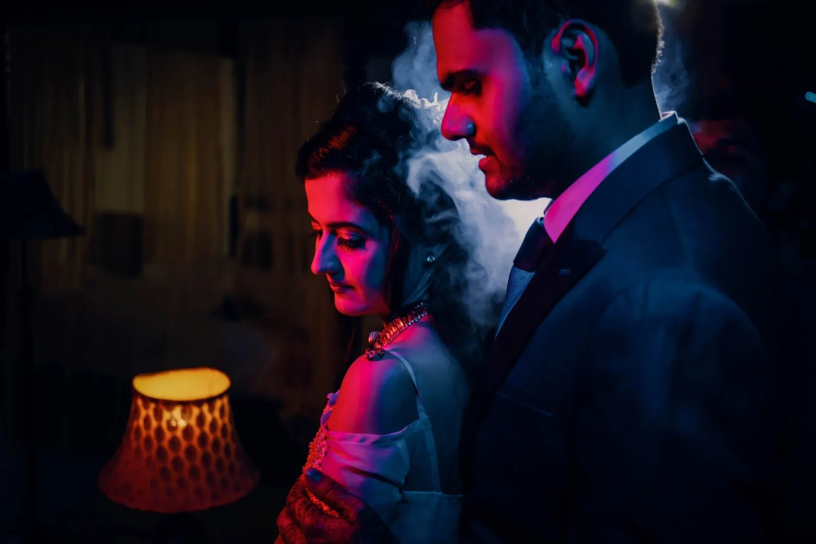 Couple in formal wear posing close together, wedding photography package portrait