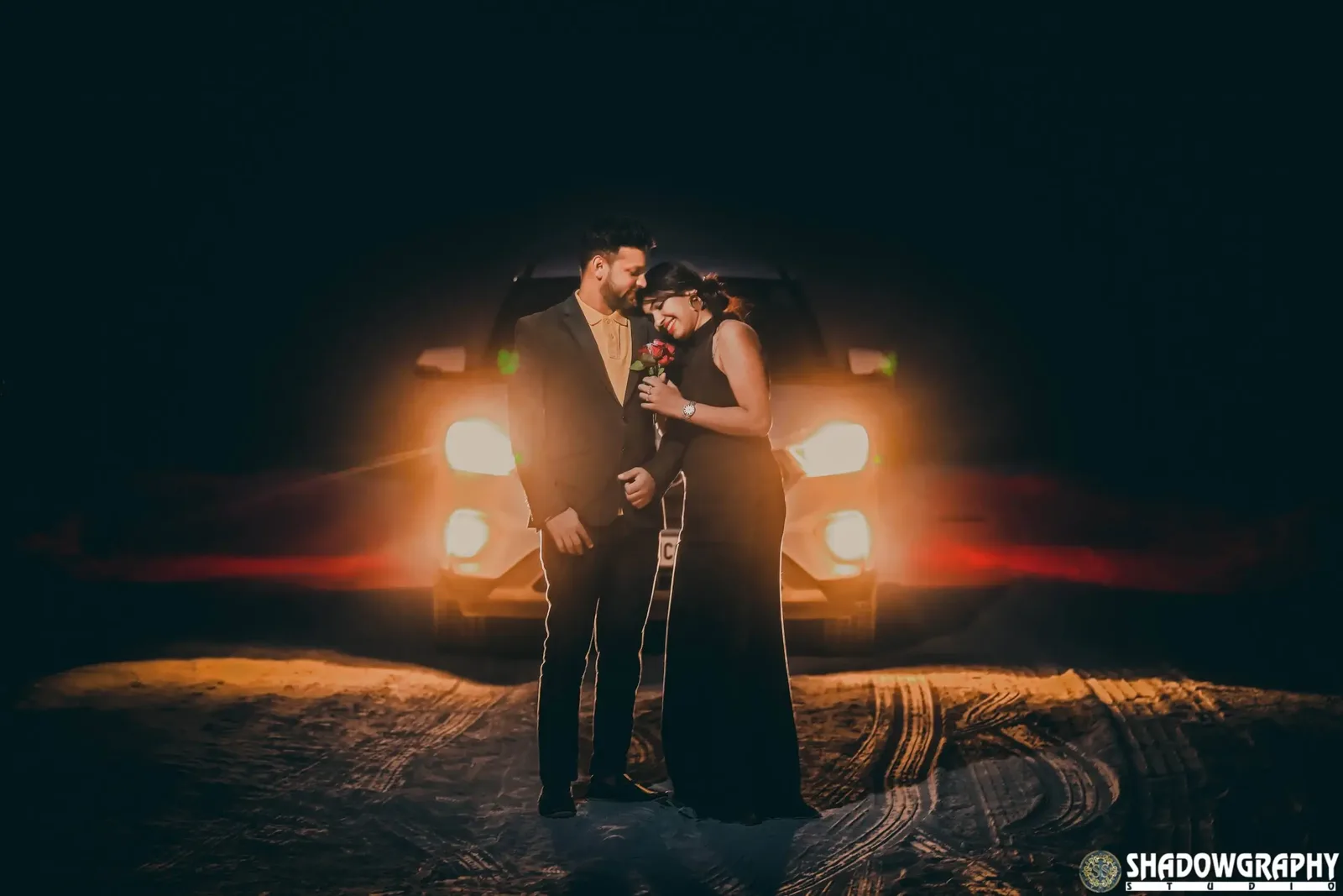 Couple shoot at night with car headlights