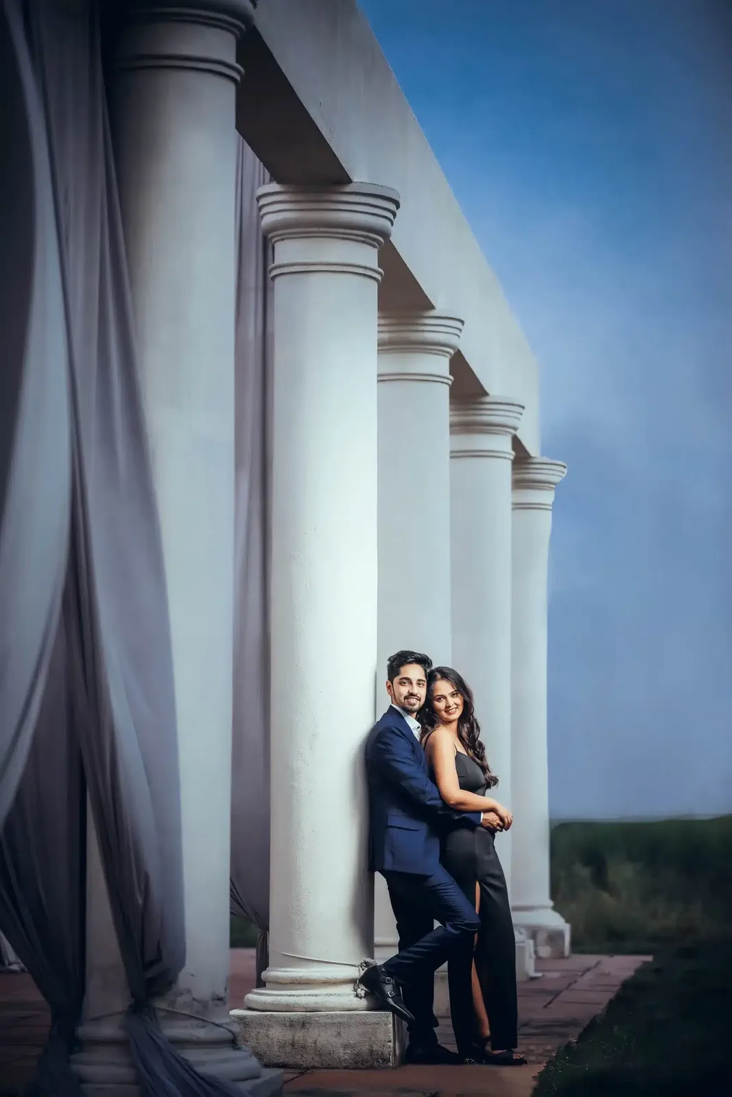 Couple portrait between old stone pillars, pre-wedding photography in Indore