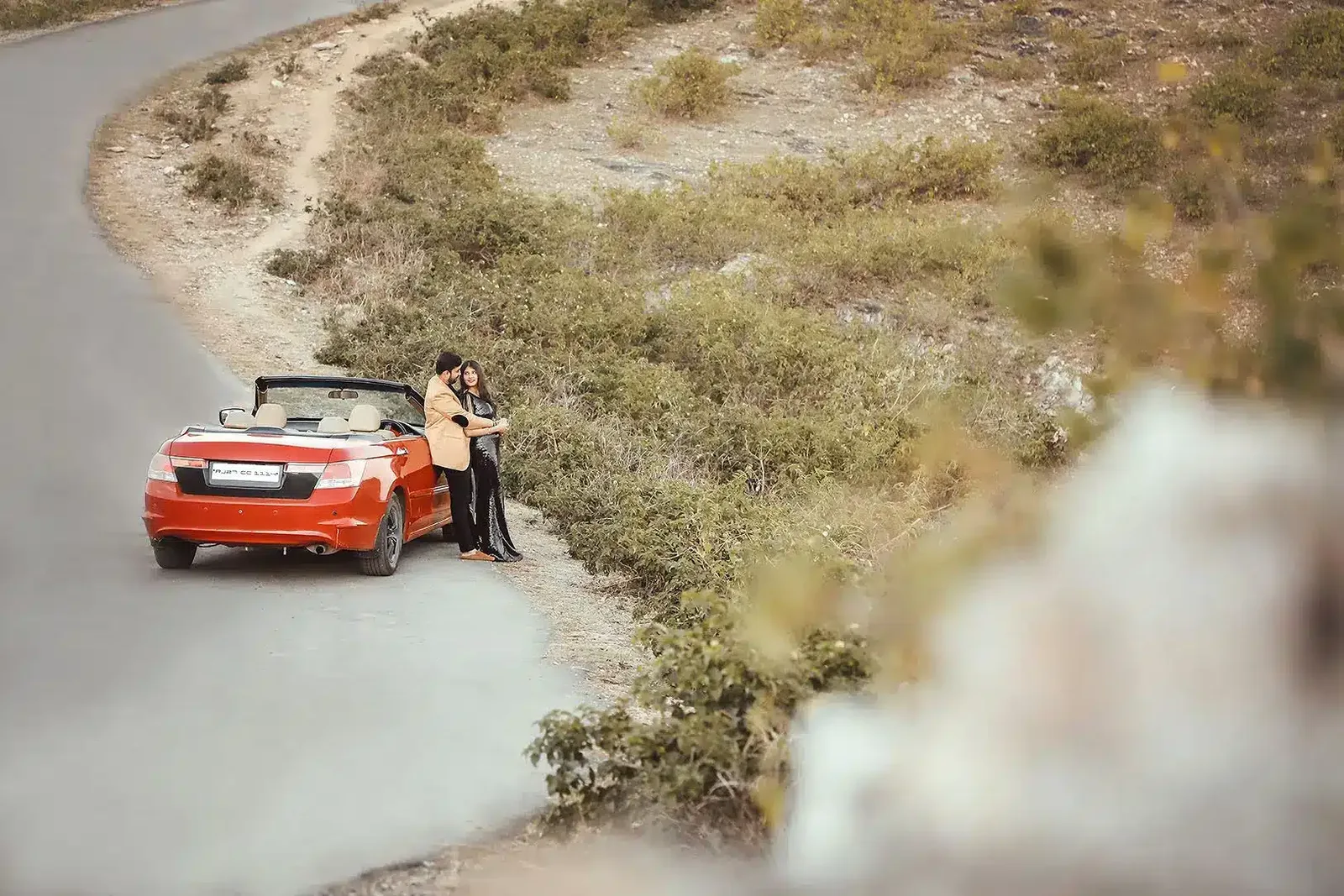 Couple on a quiet road with open landscape, pre-wedding shoot
