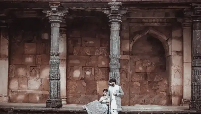 Pre-wedding couple beside stone pillars at Mandu near Indore