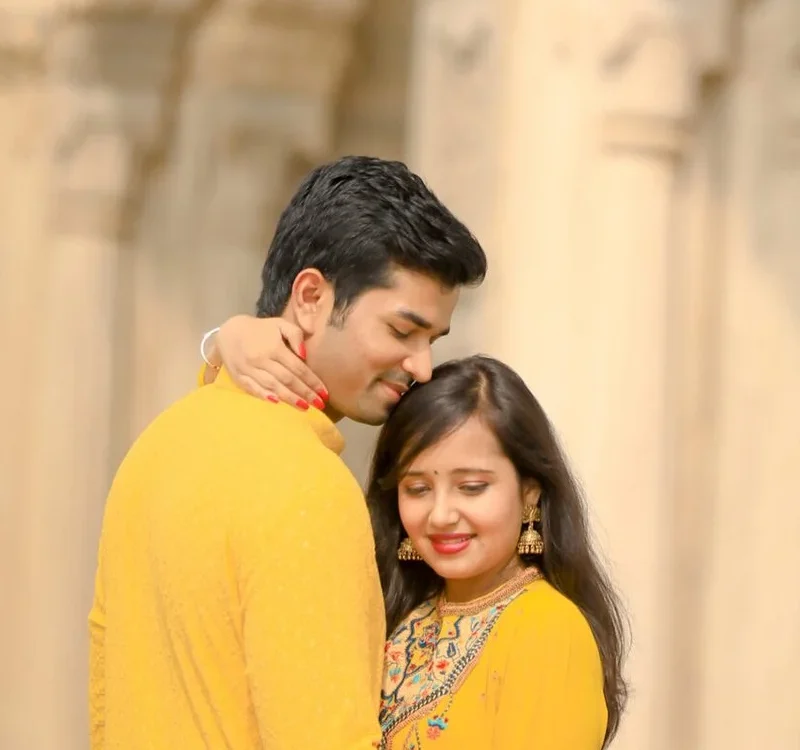 Couple in yellow traditional outfits during a luxury pre wedding shoot at a heritage building